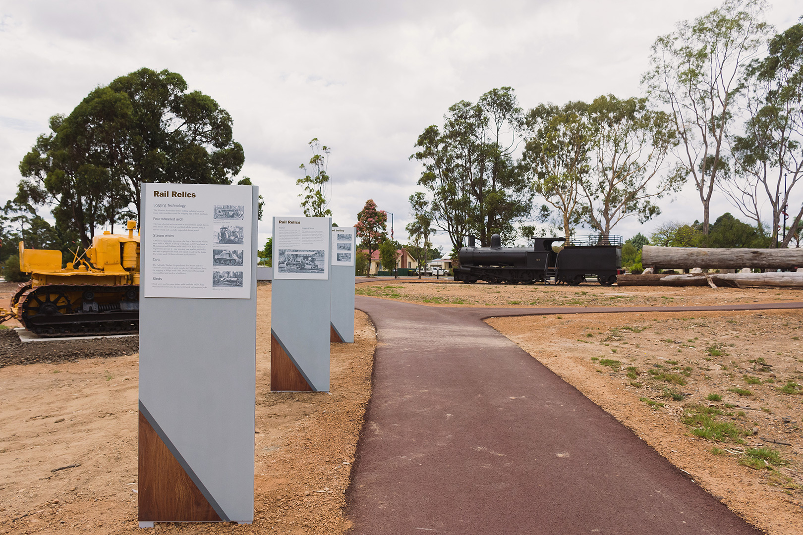 interpretative signage along pathway with rail display in the background