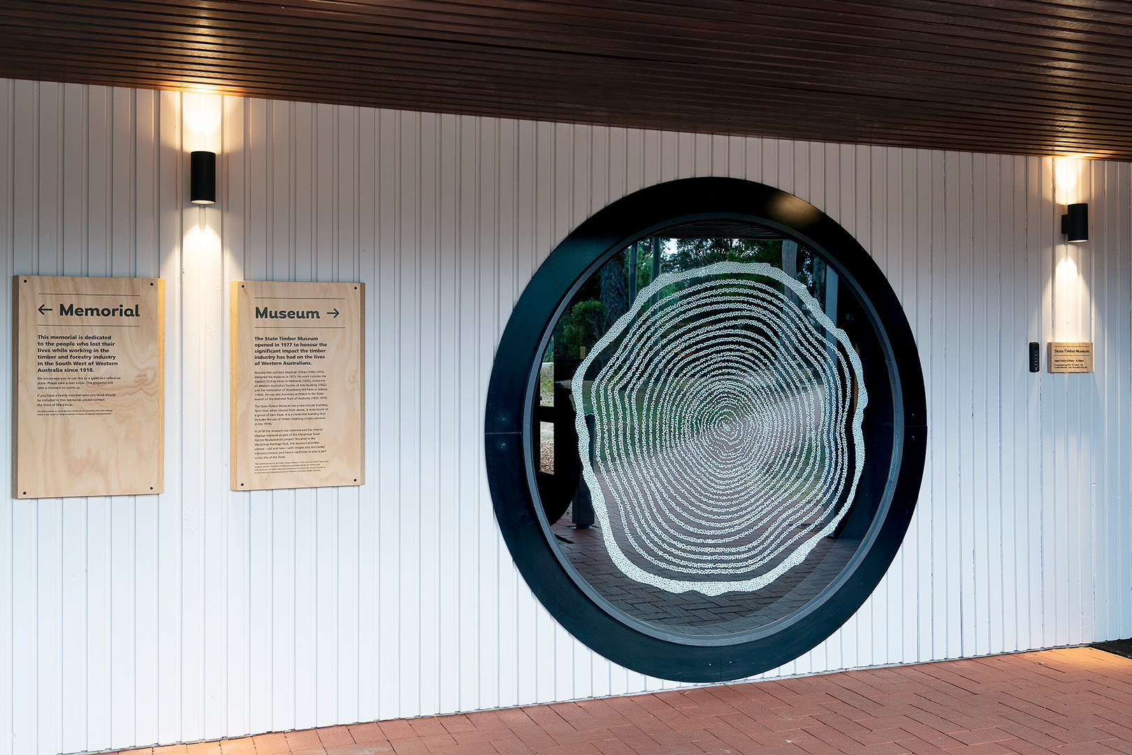 enter of timber museum featuring large circular window with artwork on it